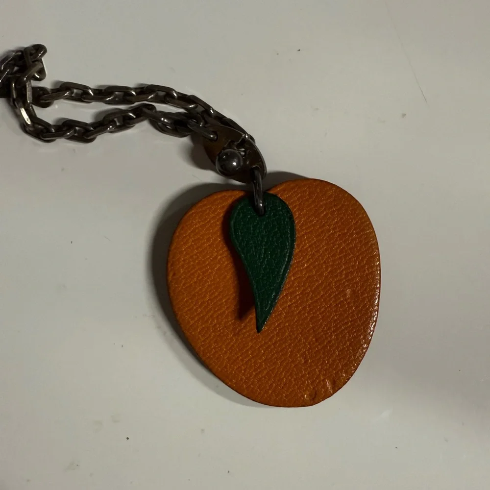 Hermes- AUTHENTIC 🍀 Orange Leather Fruit Charm with Green Leaf